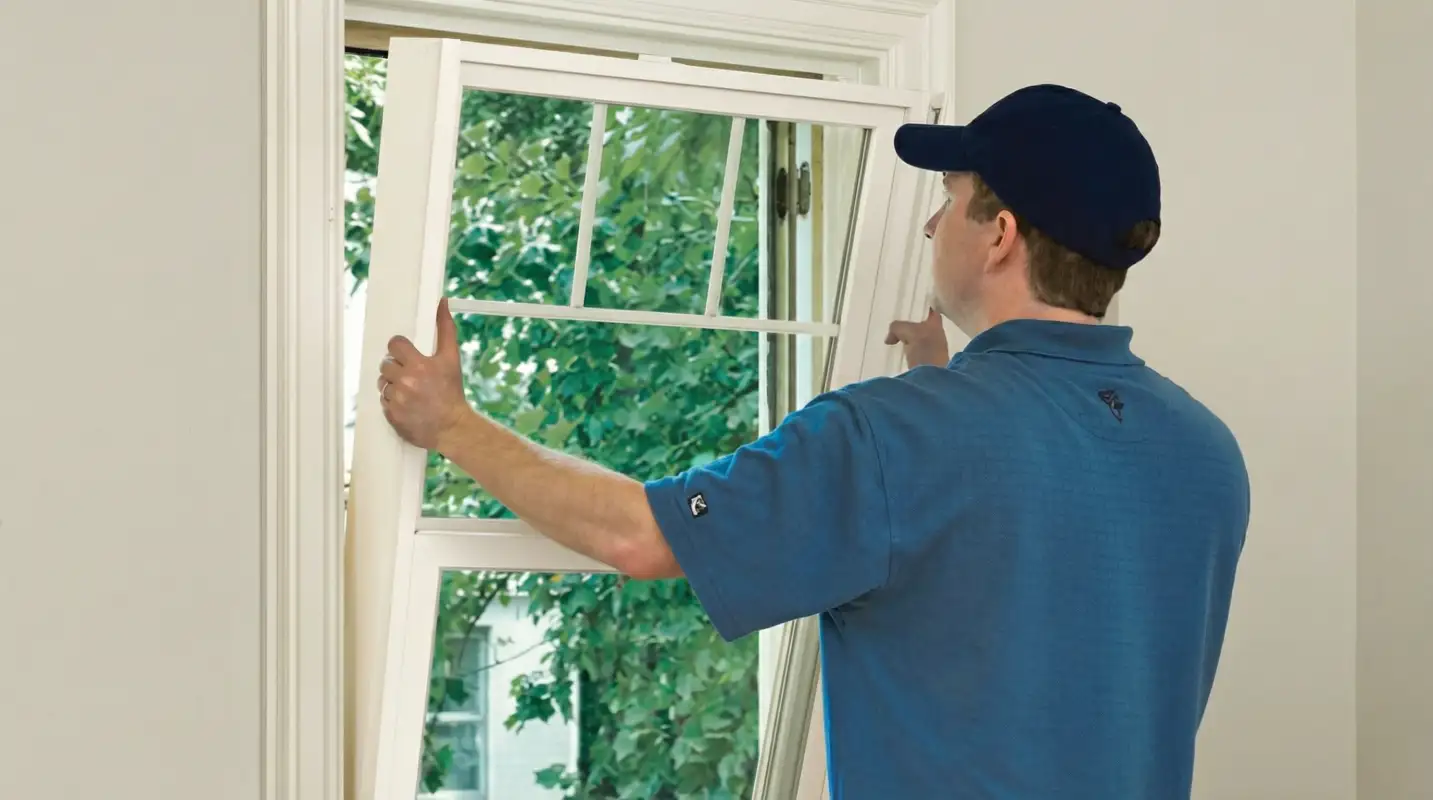 Professional contractors performing a residential window insulation and replacement service in Cedar Rapids, IA